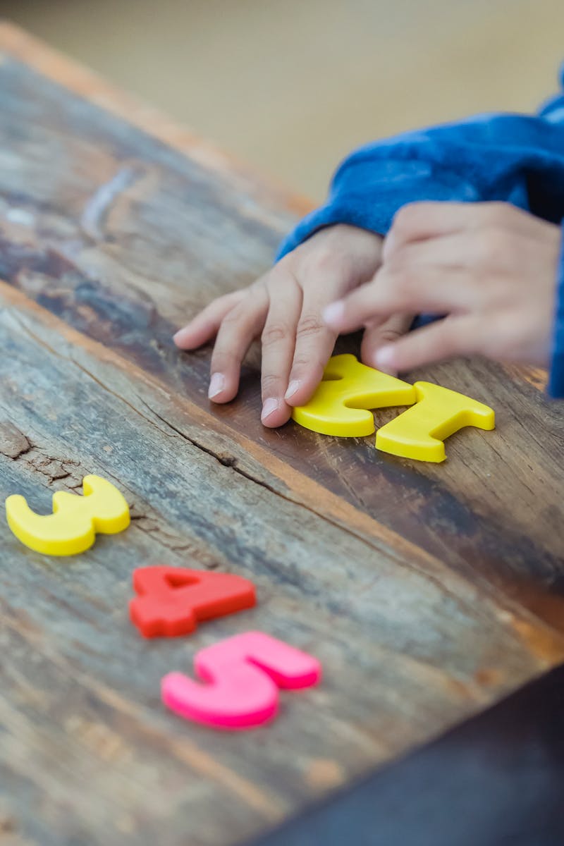 Little kid playing with plastic numbers